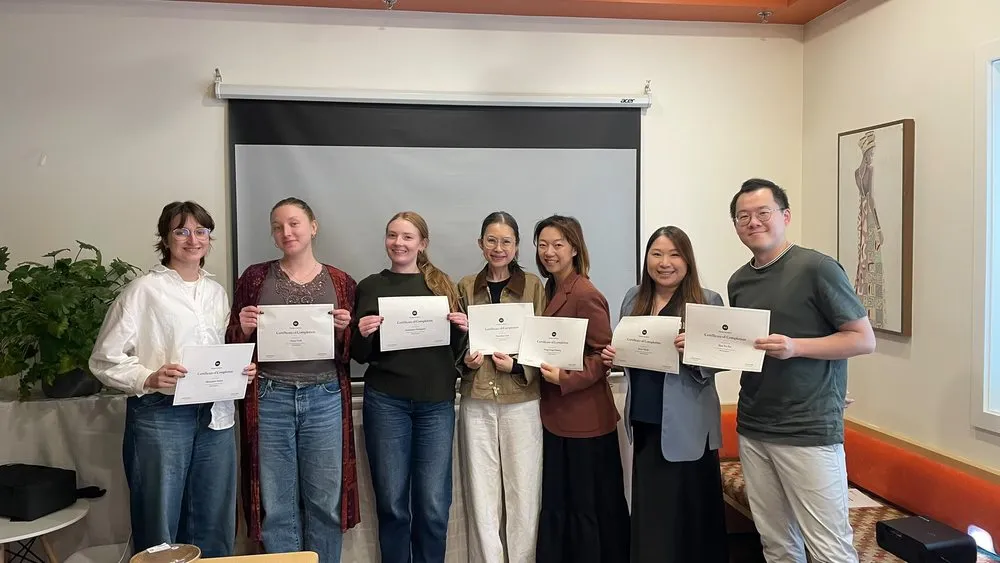 Another group of participants with their certificates of completion
